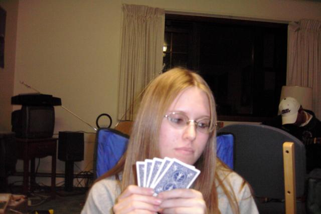 Becky's roommate, Rachel, playing cards at Mike's apartment