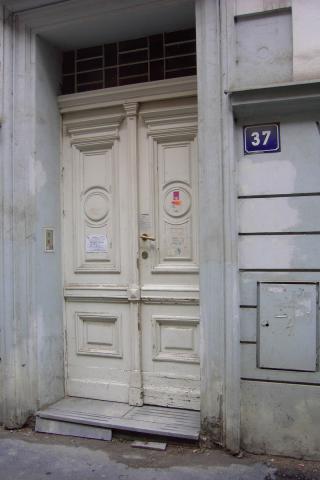 This is the front door to our apartment building in Prague.  For all we know, that sign on the door could say that the building is condemned!